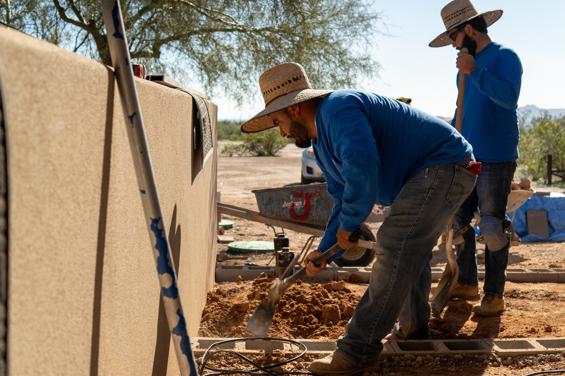 Stone Creations crew installing pavers on a job site in Arizona